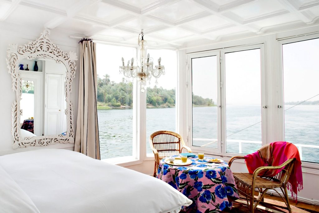 Best Nile Cruises 2025 and Traditional Dahabiya Nile boat with passengers enjoying sunset