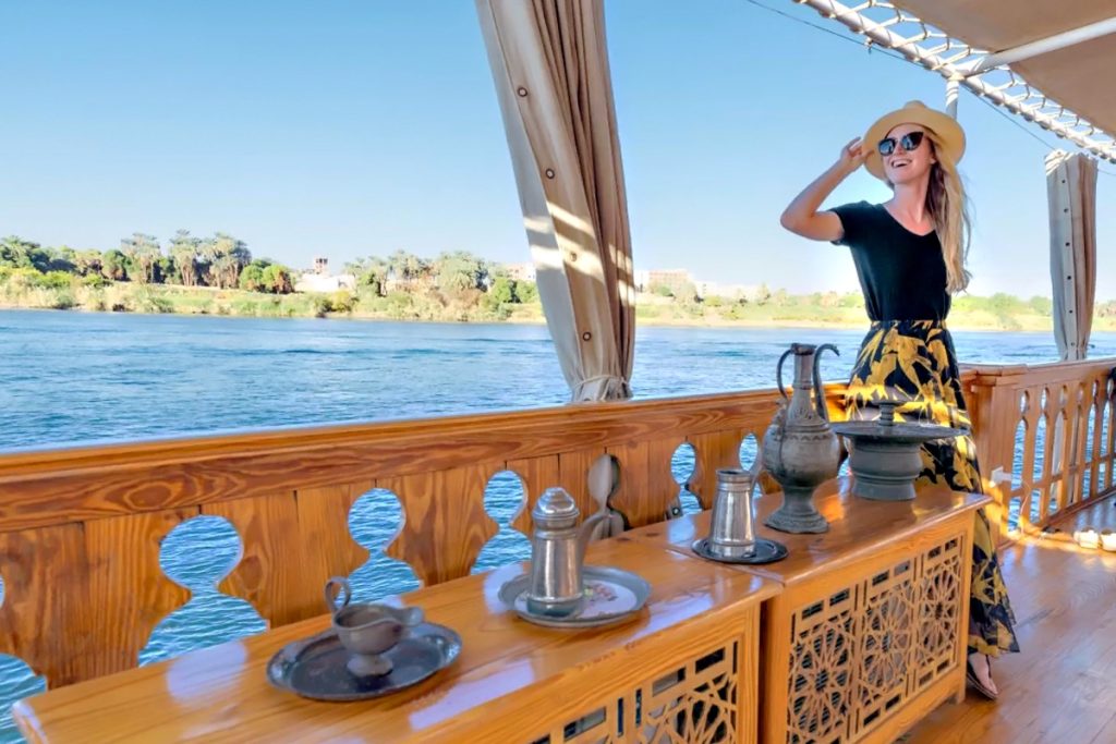 Guests enjoying tea on the deck of a Dahabiya Nile Cruise